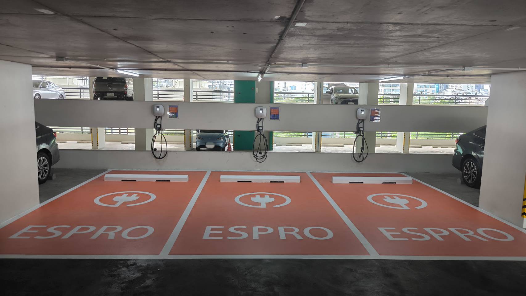 A parking Ev Charge garage with two cars parked inside.