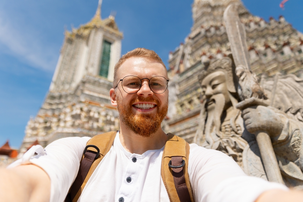 A traveller enjoying a temple, a highlight of sabbatical travel in Thailand 